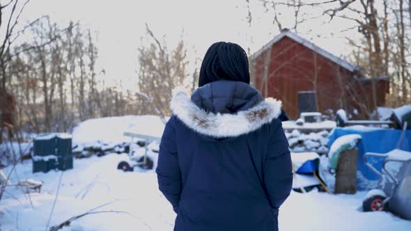 Woman walking in backyard wintertime