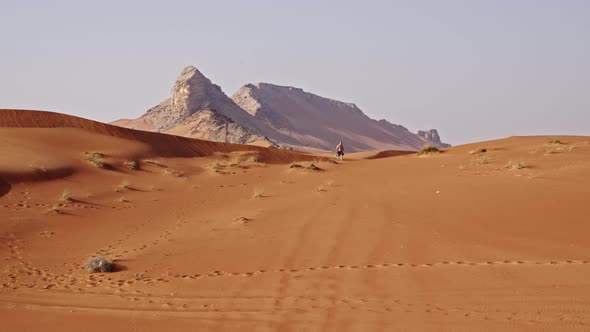 Man Walking Through Desert In Dubai