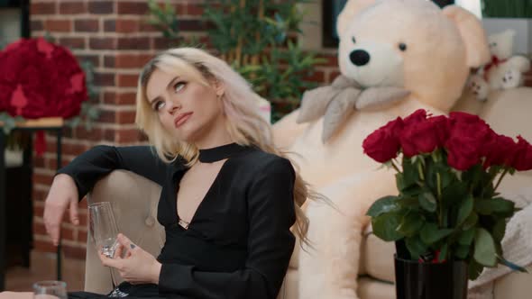 Blonde Sexy Woman with Empty Champagne Glass Waiting on Boyfriend