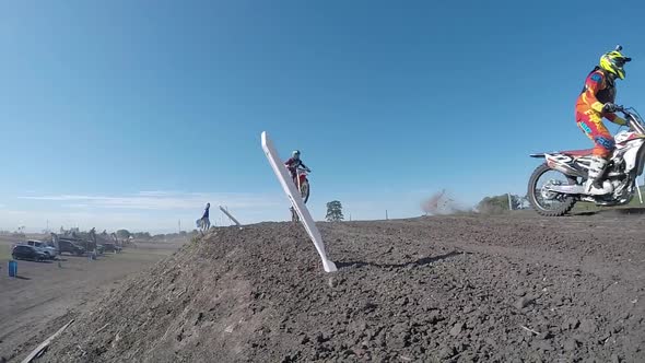 Men racing in a motocross motor sports race.