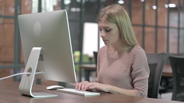 Ambitious Young Woman Working on Computer