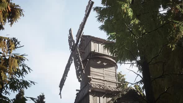 Old Traditional Wooden Windmill in the Forest alt