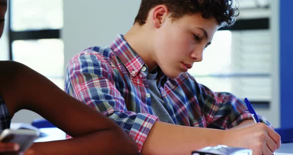 Student using mobile phone in classroom