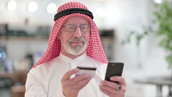 Online Payment Success on Smartphone By Old Arab Businessman 