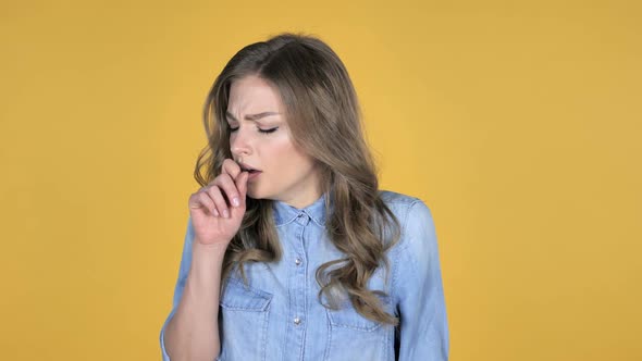 Sick Young Girl Coughing Isolated on Yellow Background