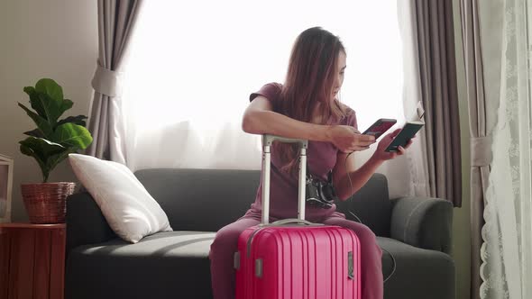 Woman hold smartphone and passport feel unhappy flight cancel for a travel trip