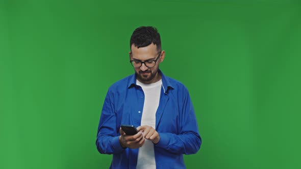 Smiling Handsome Bearded Mand in Casual Shirt Isolated on Green Background Studio