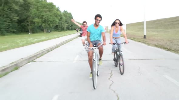 Three young adults having fun cycling