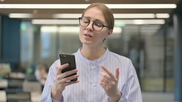 Portrait of Young Woman Reacting to Loss on Smartphone