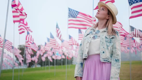 Slow Motion Beautiful Woman in the Outdoor Park with American Flags Display