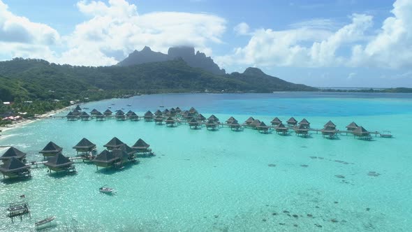 Aerial drone view of a luxury resort and overwater bungalows in Bora Bora tropical island