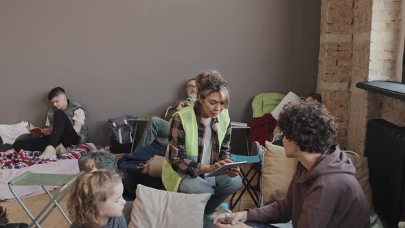 Volunteer Checking on Refugees in Shelter