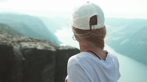 Over the Shoulder Shot of the Lysefjord River Cliff and Mountains on a Foggy Morning