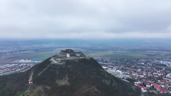 Stunning Aerial View of the Medieval Stone Fortress of Deva on a Cloudy Day