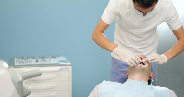 Dentist Wearing Optragate for the Male Patient