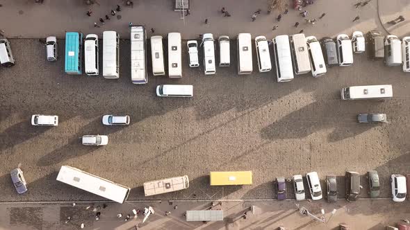 Aerial footage of many cars and buses moving on a busy city street