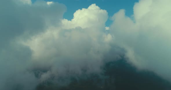 Aerial Fly Above Clouds with Blue Sky in Backgroubnd on Beautiful Sunny Day