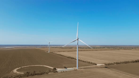 Aerial View of Wind Turbine Farm on Agriculture Fields in Ukraine on Clear Blue Sky Background