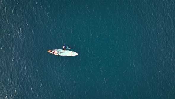 A Man Drifts Surfing the Sea Aerial View 4 K