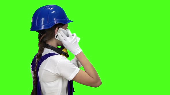 Girl in a Helmet Talking on the Phone . Green Screen. Slow Motion