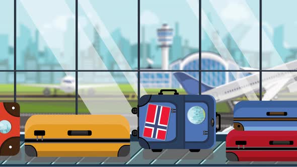 Luggage with Norwegian Flag Stickers on Baggage Carousel