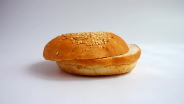 Falling hamburger bun on a white background