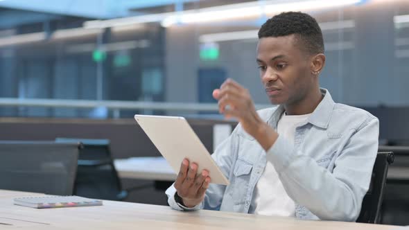 African Man Reacting to Loss on Tablet