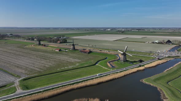 Historic Dutch Windmills in a Farm and Grass Field Landscape in The Netherlands Holland