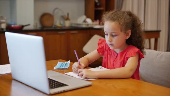 Distance Learning Online Education Schoolgirl Sits at Home at Her Desk Performs a School Assignment