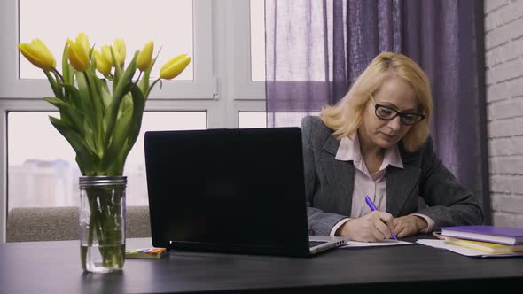 Senior Female Working on Laptop Pc at Desk