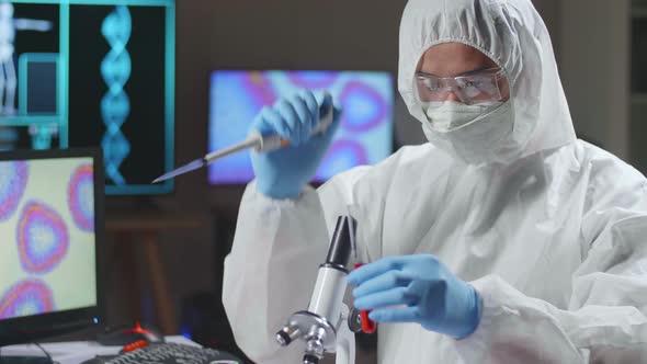 Asian Doctor In Protective Suit Is Doing A Science Experiments And Developing Vaccine