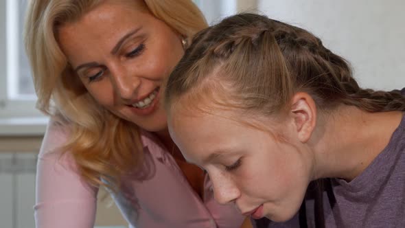 Young Girl and Her Teacher Working on Art Project Together