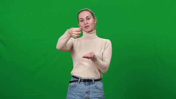 Positive Woman Imitating Virtual Cosmetics Testing on Green Screen