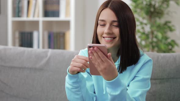 Pretty Woman Using Smartphone at Home