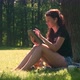 Young Woman In Park Uses Digital Tablet - VideoHive Item for Sale