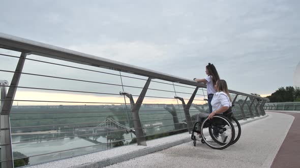 Disabled Mom with Girl Admiring View From Bridge