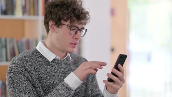 Portrait of Young Man Celebrating on Smartphone