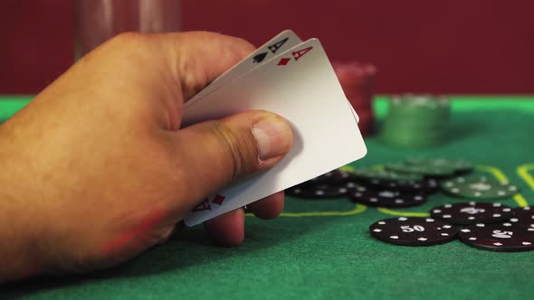 A Risky Poker Player's Hand Reveals Two Aces in Closeup