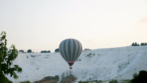 Hot Air Colorful Balloon Fly Over the White Limestone Mountains