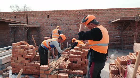 Builders Building a Brick Wall