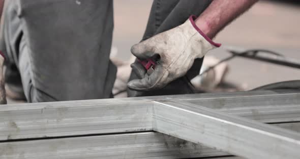 Steel Worker Assembling Metal Frame Made Of GI Tubular 