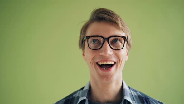 Close-up Portrait of Silly Male Student Rotating Eyes Making Funny Faces