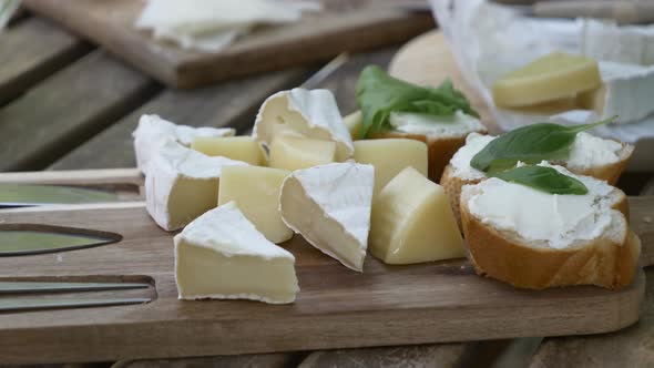 Cheese desk with snacks on wooden table