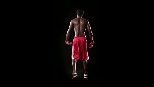 Man Stretching Isolated on Black