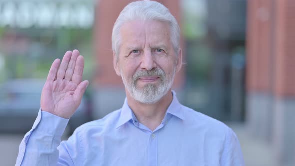 Outdoor Old Man Waving at Camera