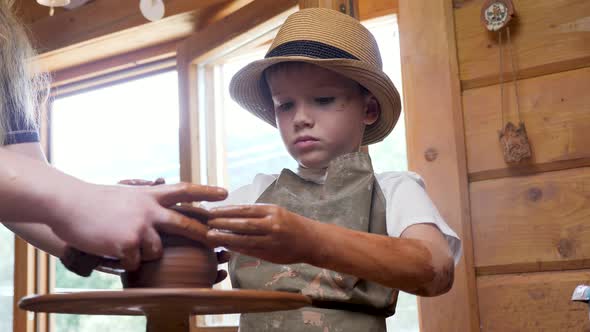 Ceramic Potter Teaches Child Craft