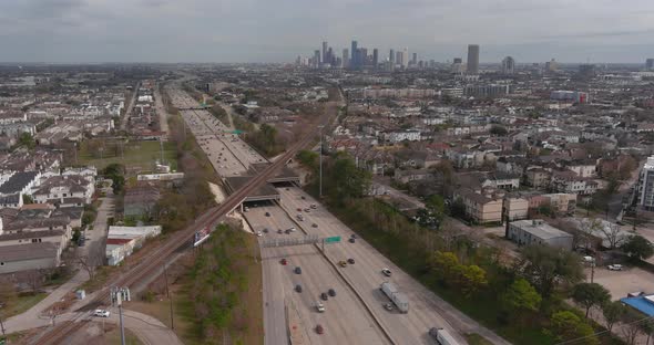 Establishing shot of cars on I-10 West freeway with downtown Houston in the background