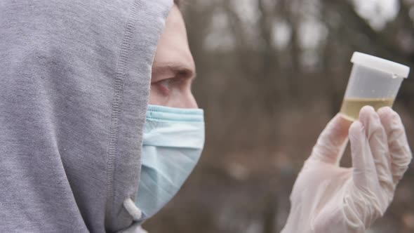 An ecologist takes a water test in a river.