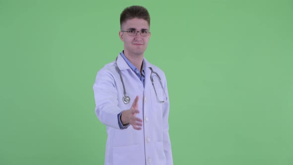 Happy Young Man Doctor Giving Handshake