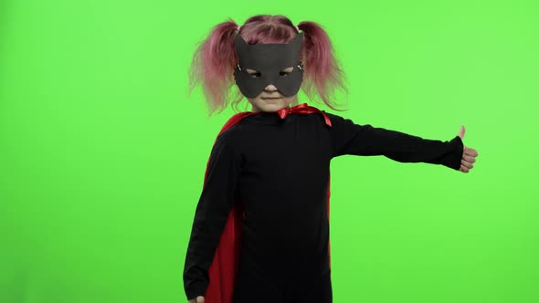 Funny Child Girl in Costume and Mask Plays Super Hero. National Superhero Day